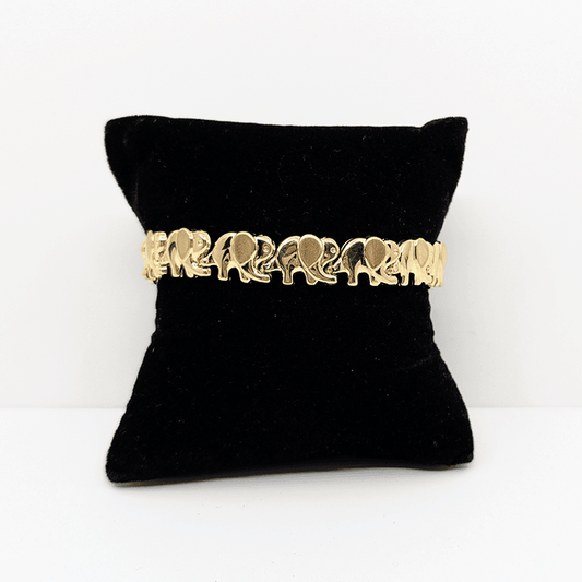 A 10k yellow gold elephant bracelet with a cubic zirconia accent on the end.