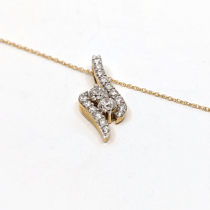 A 14k yellow gold necklace with a 0.76ctw natural diamond pendant design.