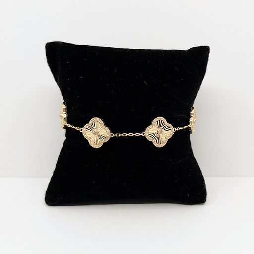 A 14k gold dainty chain bracelet with 14k gold clover charms with a cubic zirconia accent throughout.
