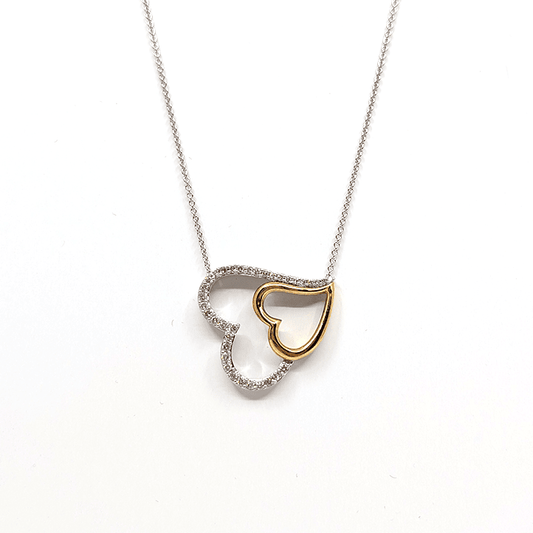 A sterling silver necklace with a dual tone heart pendant, designed with gold plating and .5ctw natural diamond. Length: 20"